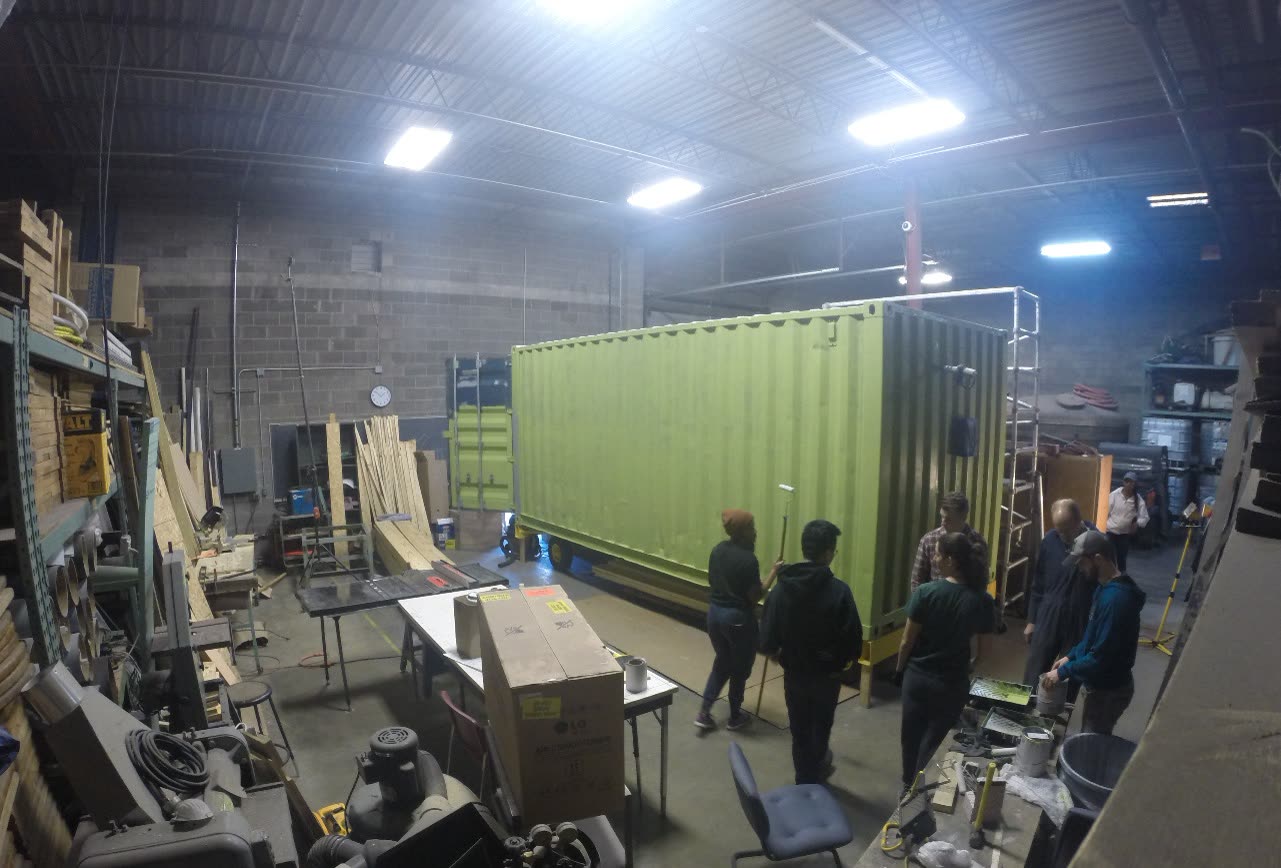 Studio class working around the shipping container in the workshop