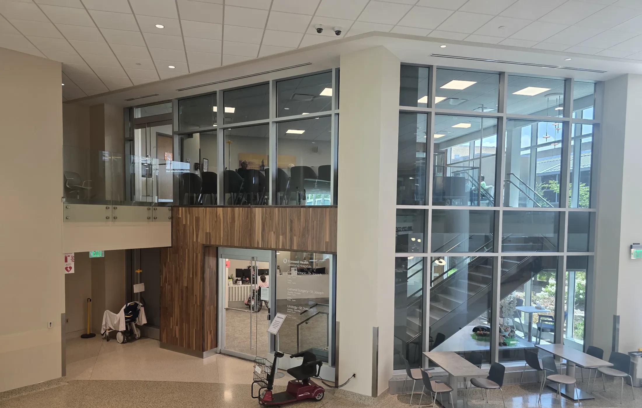 Completed public arrival at the St. Joseph Hospital Tower C Integrated Care Campus, with a glazed stair and wood feature wall