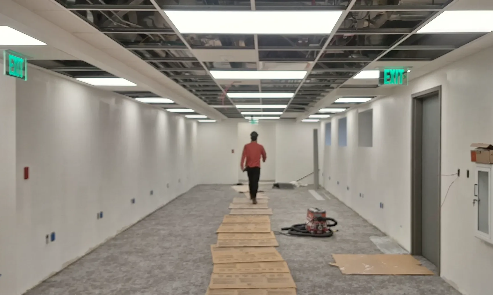 Tower C Integrated Care Campus corridor during construction, with ceiling and wall work in progress